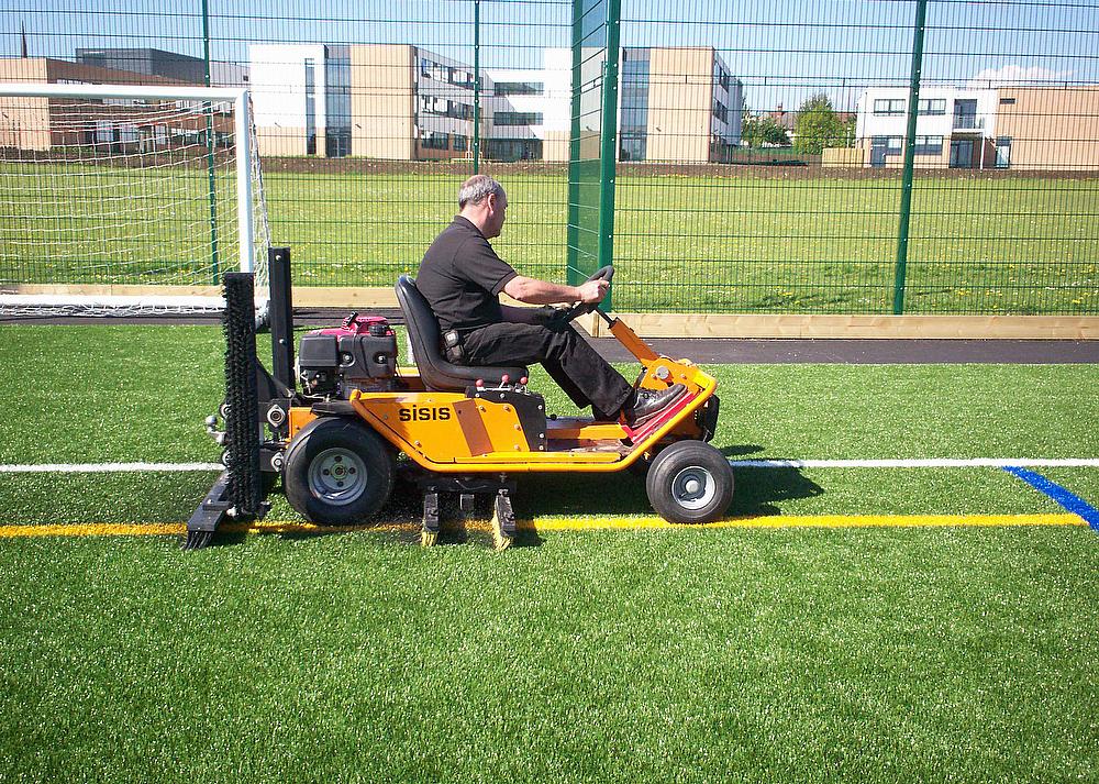 Article - Andy-Walker-Field-Support-Manager-for-Dennis-and-SISIS-demonstrates-the-SISIS-Brush-Pro-at-one-of-the-synthetic-sports-pitches-that-White-Horse-Cont